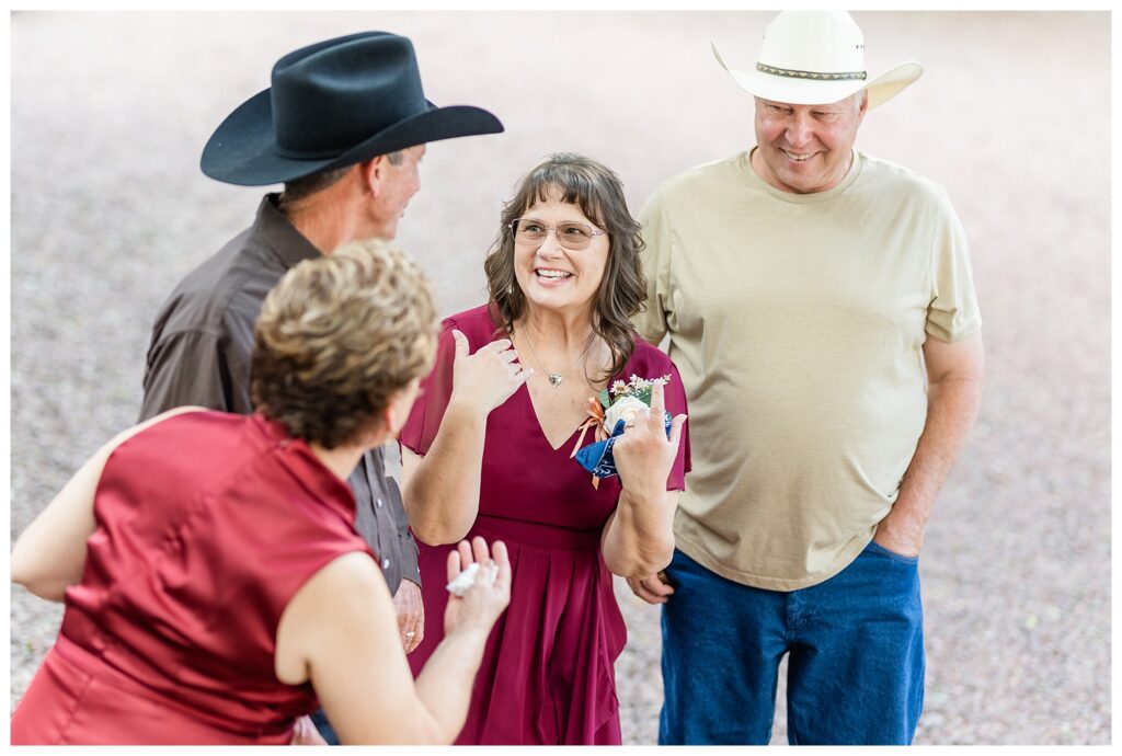 Parents talking excitedly at wedding. 