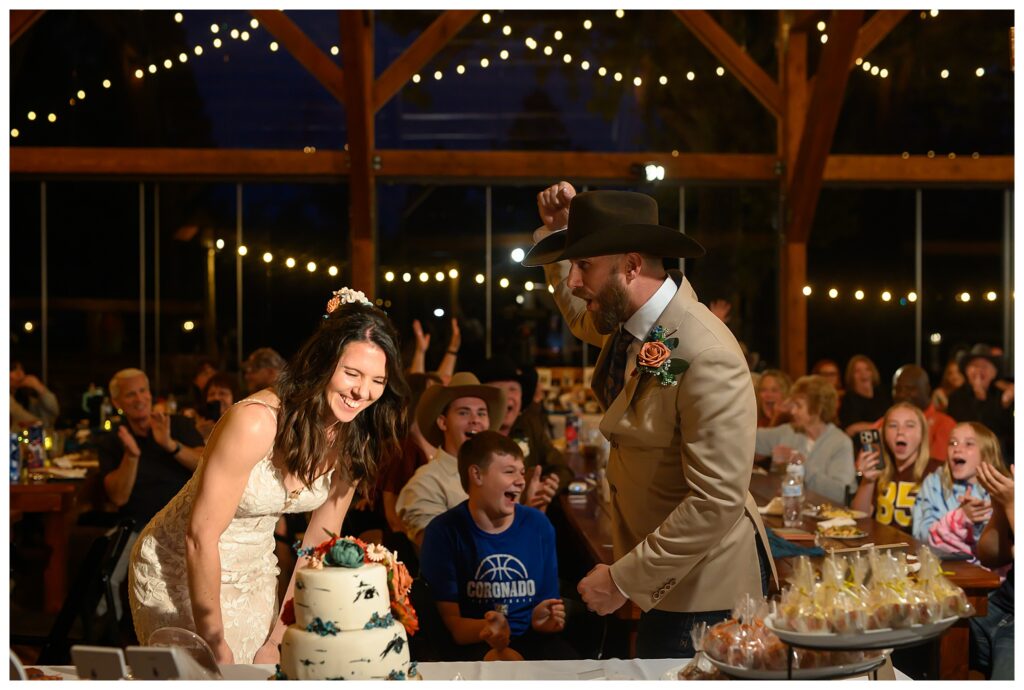 Bride and Groom laughing during cake cutting