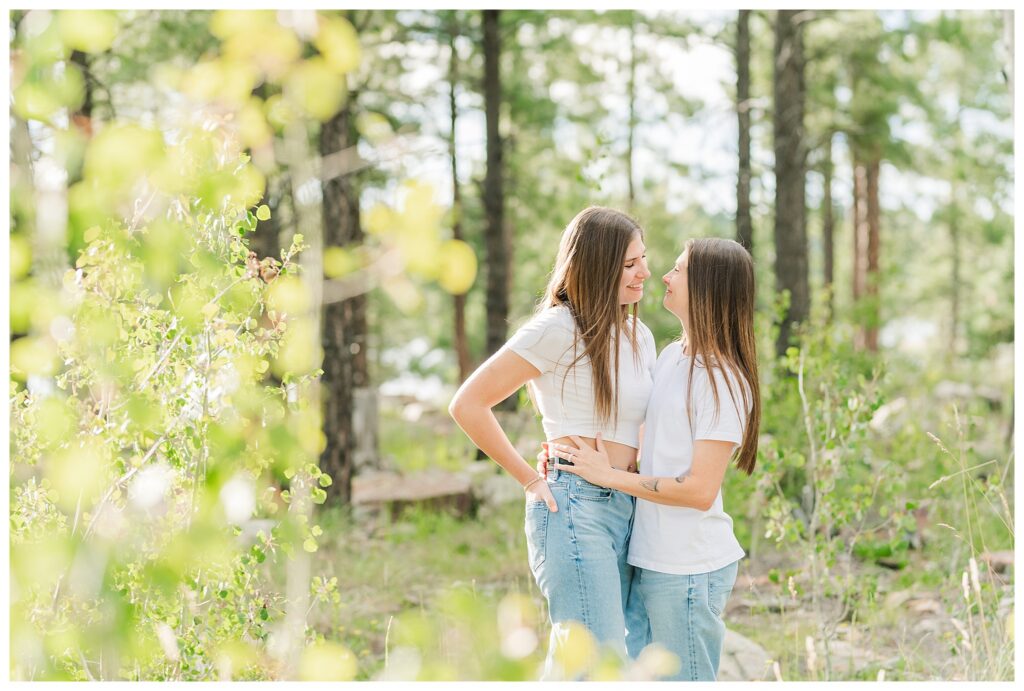 Couple standing in forest at Willow Springs Lake for their engagement photos