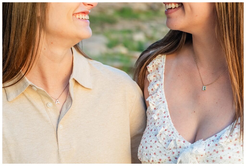Couple with coordinating necklaces of each other's initials 